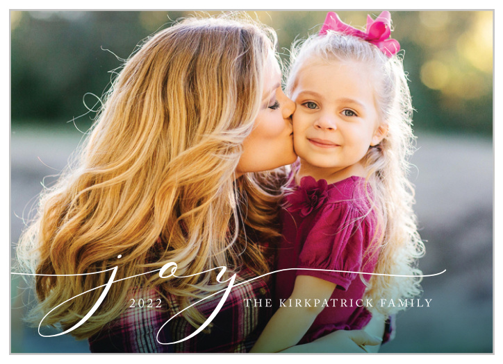 Our Scripted Joy Holiday Cards offer a minimalist design for those who want to keep it simple this holiday season. Your photo serves as the background of the card, with a dark green border at the bottom fading upwards toward the text. Sweeping cursive letters spell out "joy", but you can include your own customized holiday well-wishes and your family name. These holiday cards are dignified in their simplicity and clean design.