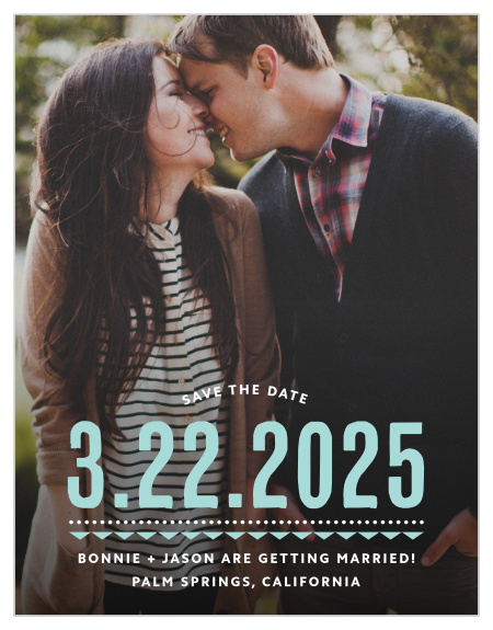 Deco Charm Save-the-Date Magnets begin with a photo of the two of you as their foundation, add the date of your wedding in a stunning glass-blue, and then finish with the other details of your wedding in small, sheer white typeface at the bottom.